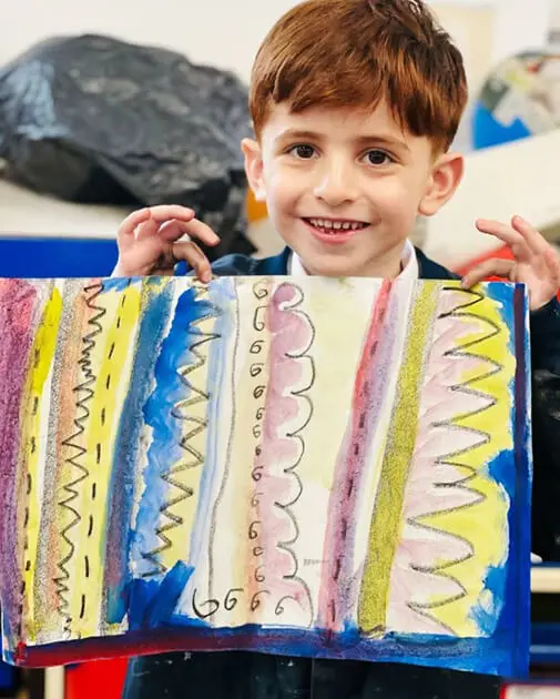 A pupil at The Ryleys School, a private school in Cheshire, showing their Kandinsky-inspired artwork