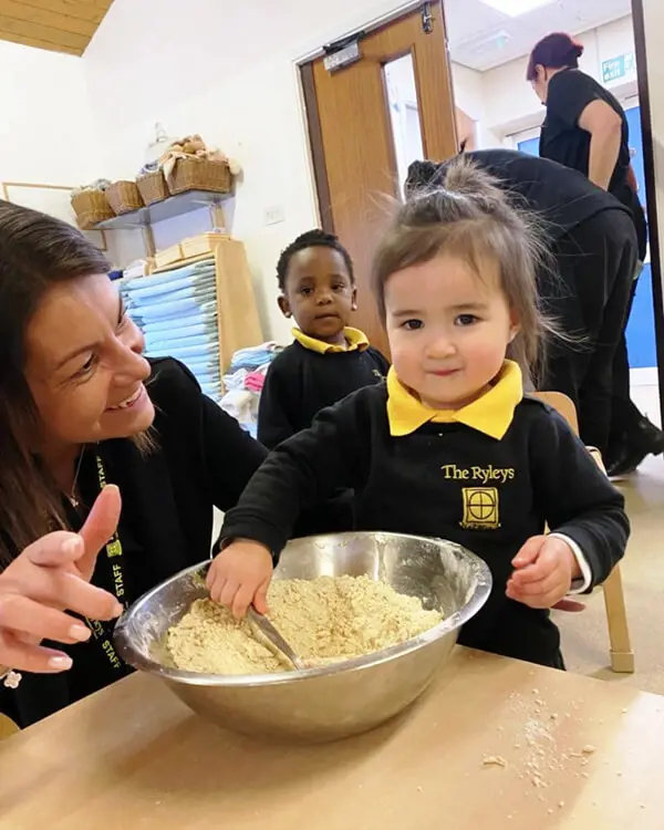 Pupils at Nursery at The Ryleys School, a private school in Cheshire, baking gingerbread men