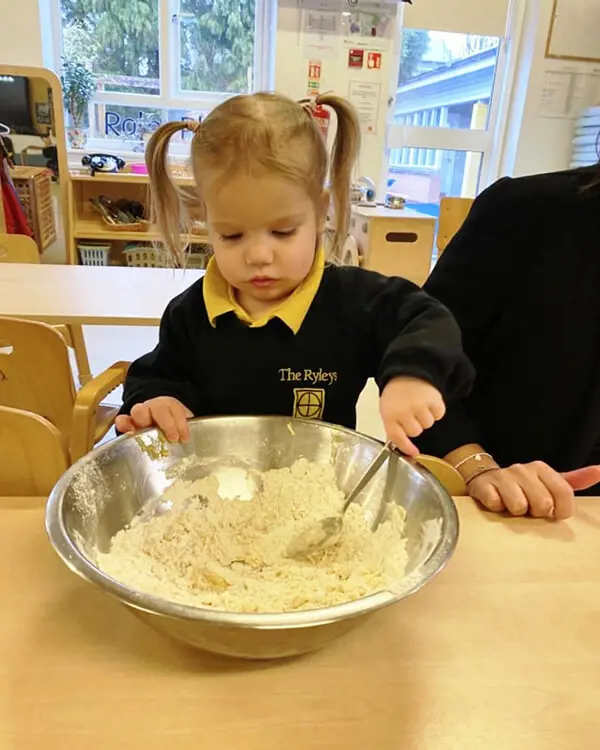 Pupils at Nursery at The Ryleys School, a private school in Cheshire, baking gingerbread men