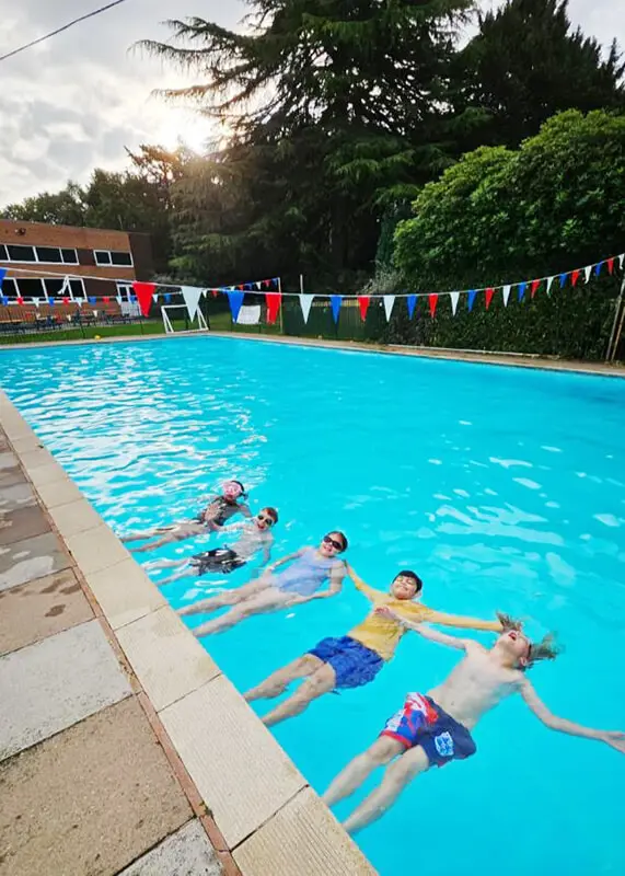 Pupils swimming and enjoying the pool at The Ryleys School, a private prep school in Alderley Edge, Cheshire