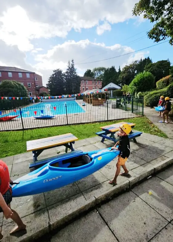 Pupils swimming and enjoying the pool at The Ryleys School, a private prep school in Alderley Edge, Cheshire