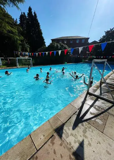 Pupils enjoying water polo in the swimming pool at The Ryleys School, a private school in Cheshire