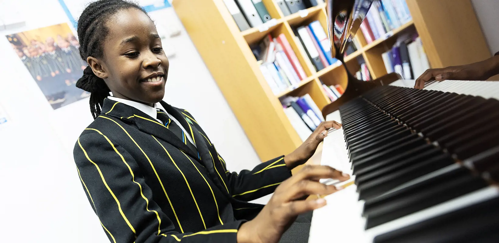 Prep school pupil playing piano at The Ryleys School, a private school in Alderley Edge.