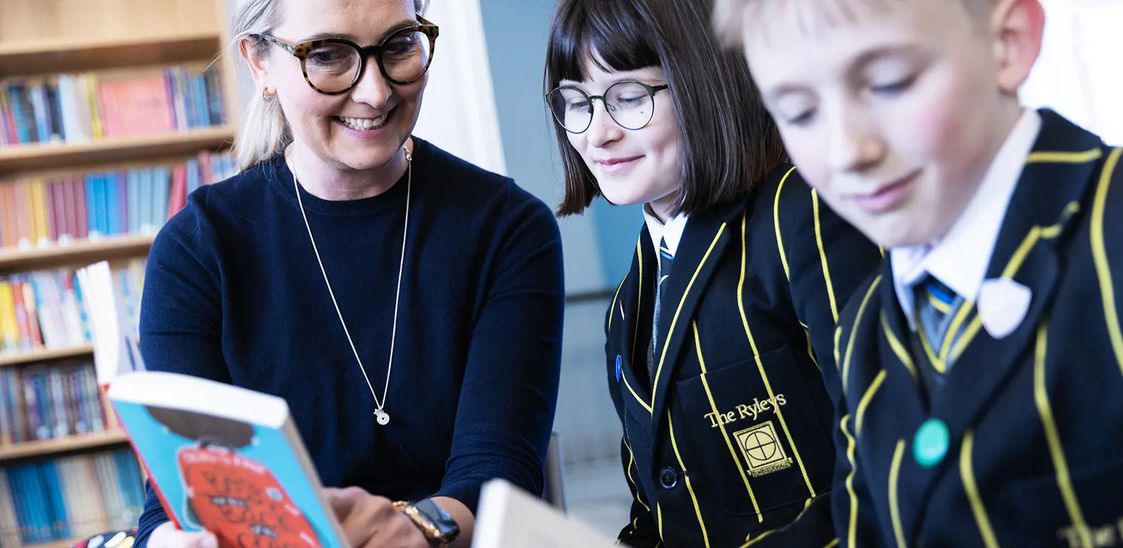 Prep school pupils reading with their teacher at The Ryleys School, a private school in Cheshire